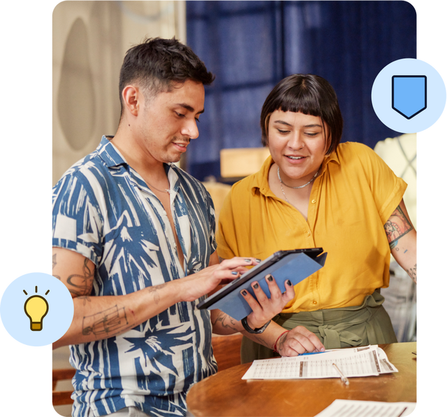 Two colleagues collaborating with digital tablet indoors